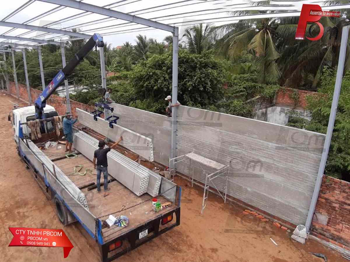 Xe cẩu cẩu hạ tấm tường bê tông lõi rỗng HCW giúp rút ngắn thời gian thi công vách xưởng.